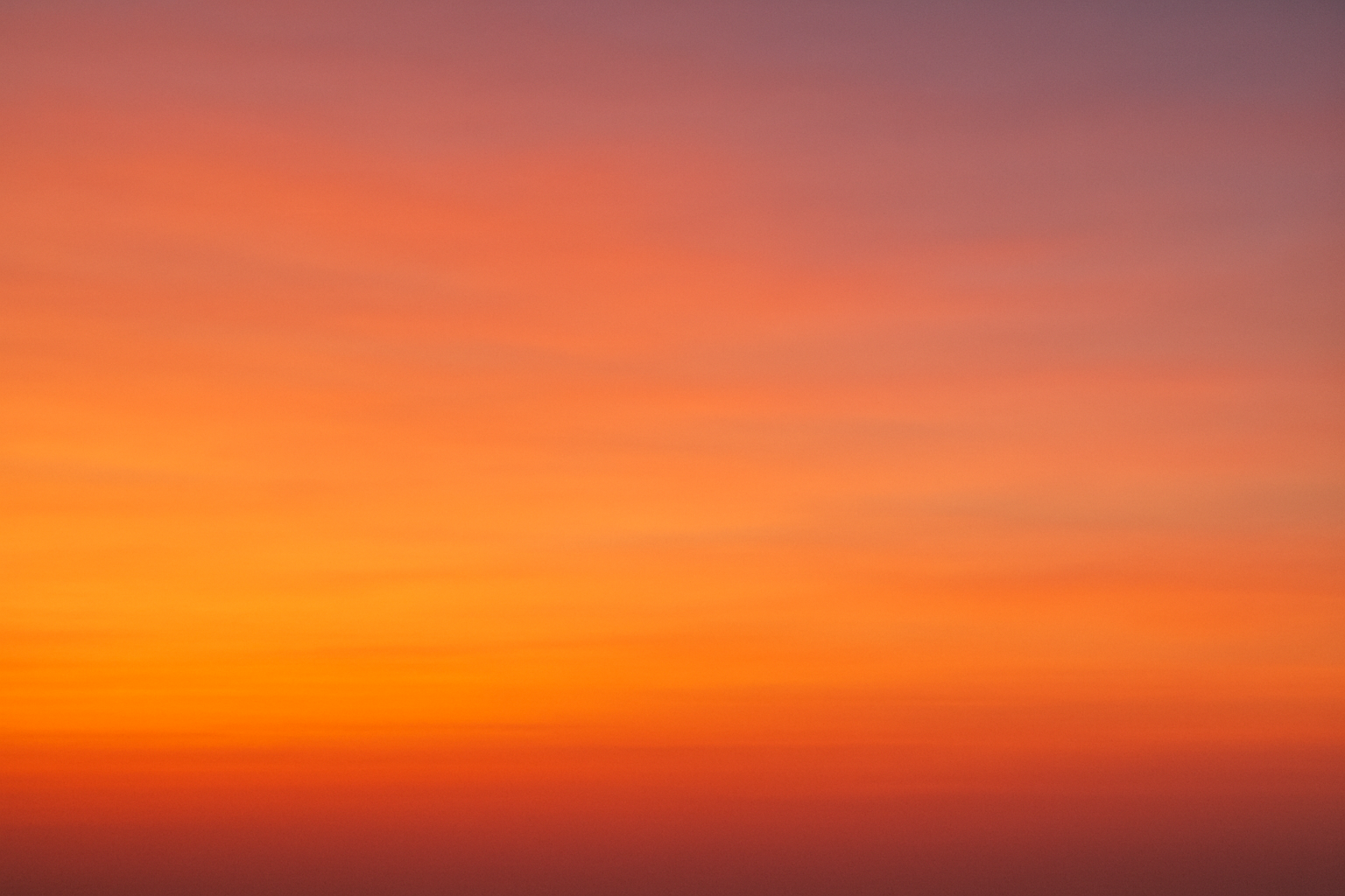 Generate a soft African sunset coloured background without trees.